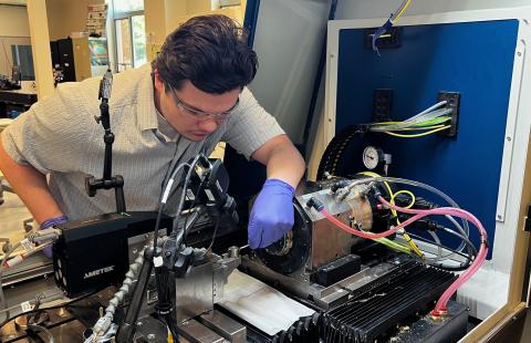 Alex works on diamond turning machine